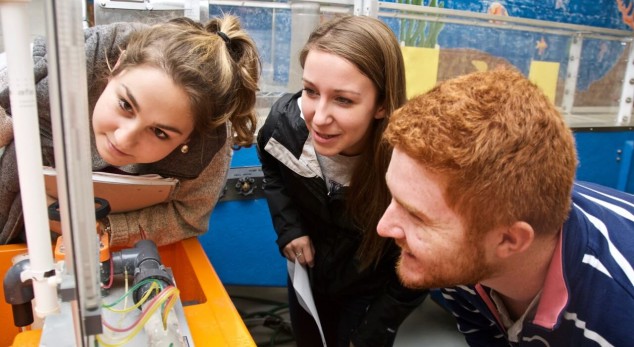three students in hydraulics lab