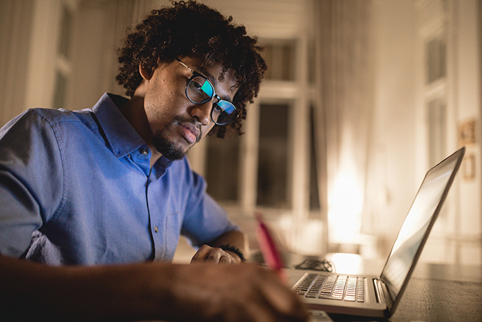 student studying at home with laptop